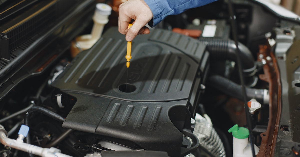 Check_your_oil A person checking their car oil