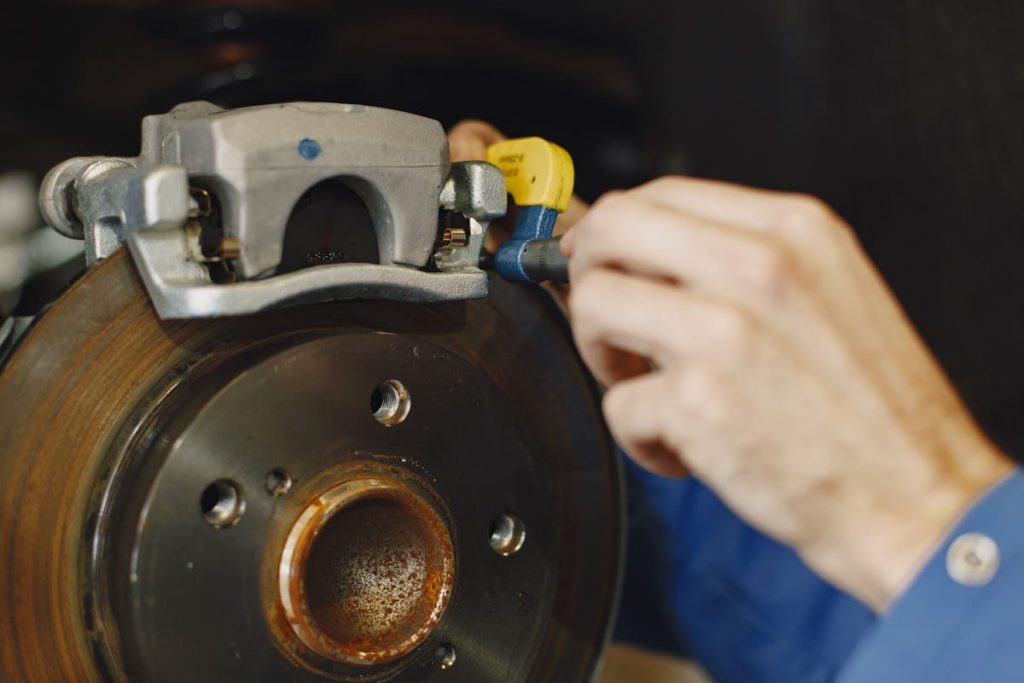 A mechanic replacing a car's brake discs