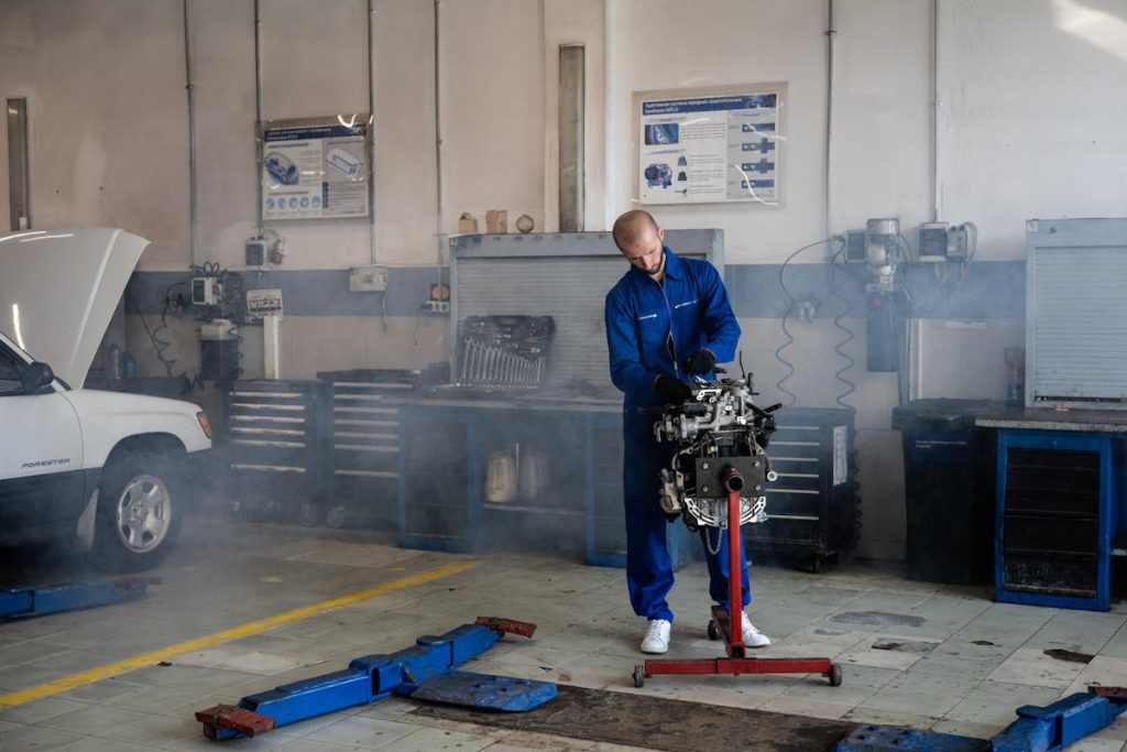 A mechanic fixing an engine