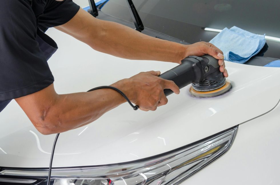 A person polishing a car